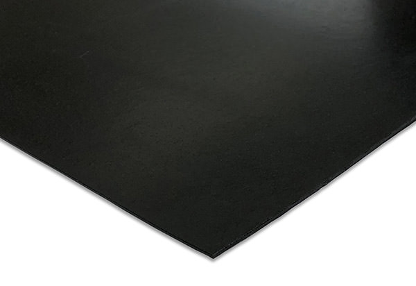 Rolls of black polymer geomembrane liner beside a high visibility marker membrane on a prepared formation