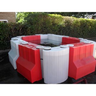Modular Floodstop barrier system creating water containment area with red and white interlocking units