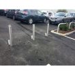 Galvanised retractable bollards with lockable design for car park security, preventing unauthorised parking in restricted areas.