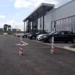 Retractable parking posts with reflective stripes, providing high-visibility access control and vehicle security for commercial sites.