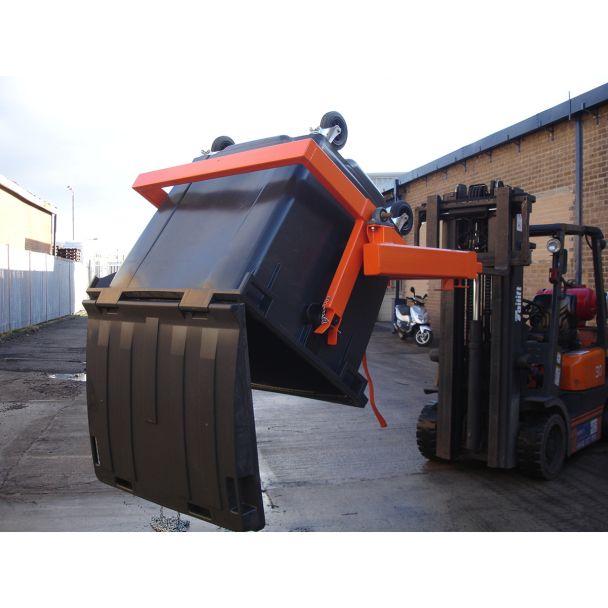 Forklift attachment lifting and tipping industrial wheelie bin, ideal for heavy-duty waste management and recycling tasks.