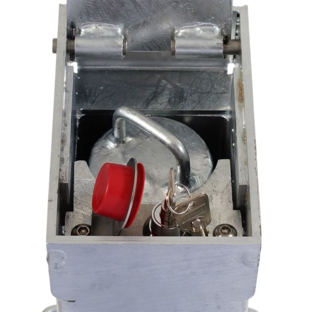 Retractable parking post with lock and keys stored in red protective housing, offering robust driveway and car park access control solution.