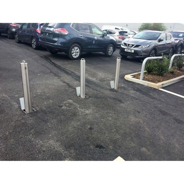 Galvanised retractable bollards with lockable design for car park security, preventing unauthorised parking in restricted areas.